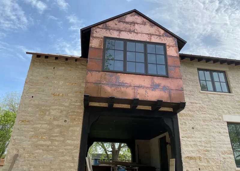 Copper metal panel facade on a stone building for Metal Roof Coating in Cocoa