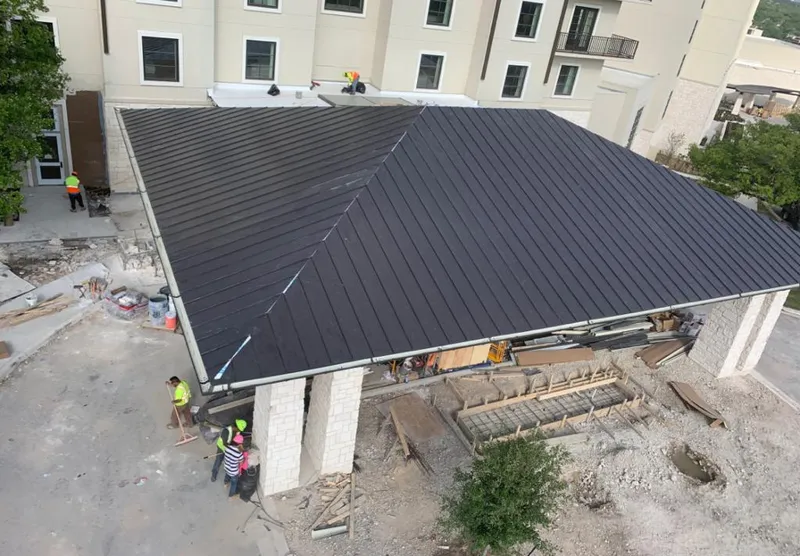 Metal roofing installation team working on a commercial building in Cocoa